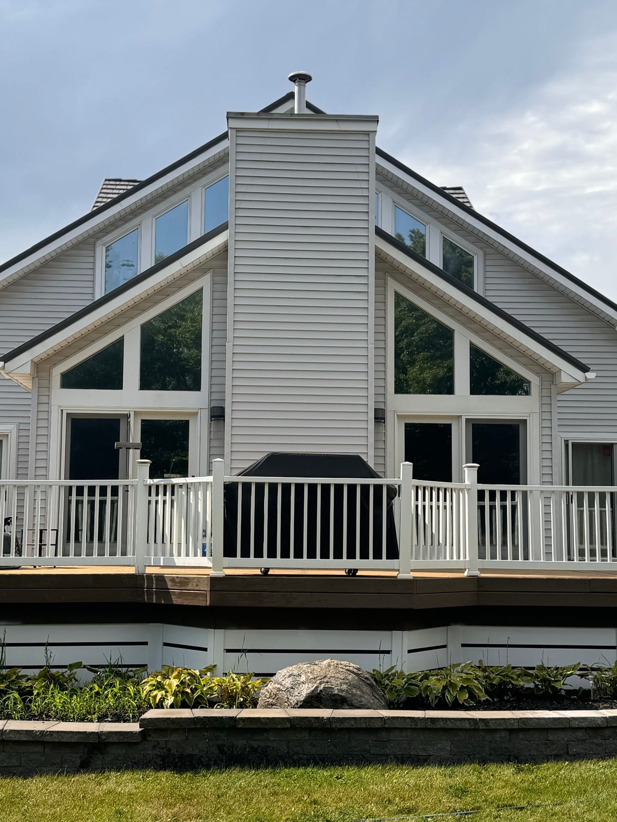 A-frame lake house with tinted glass gable
