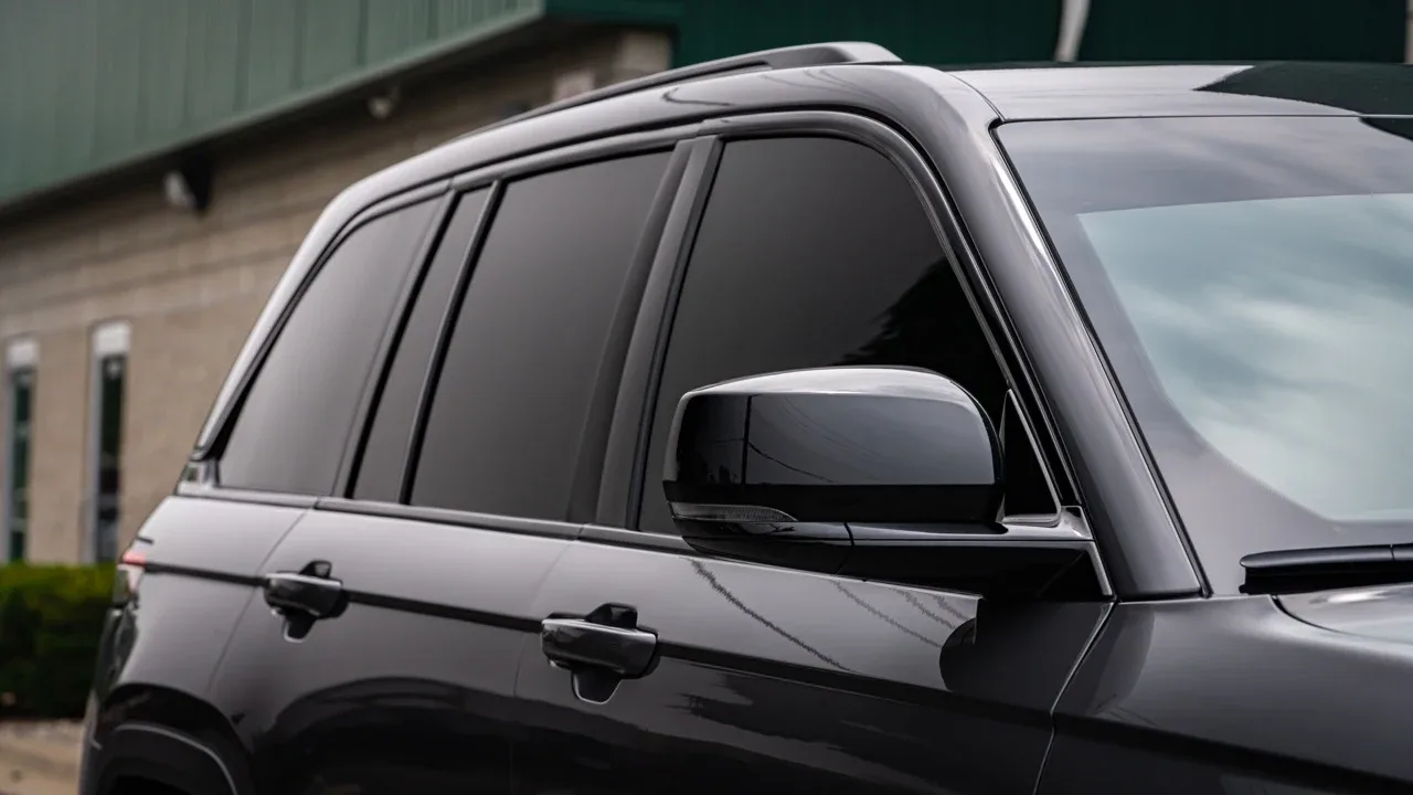 Ceramic tint detail on a black SUV's rear windows