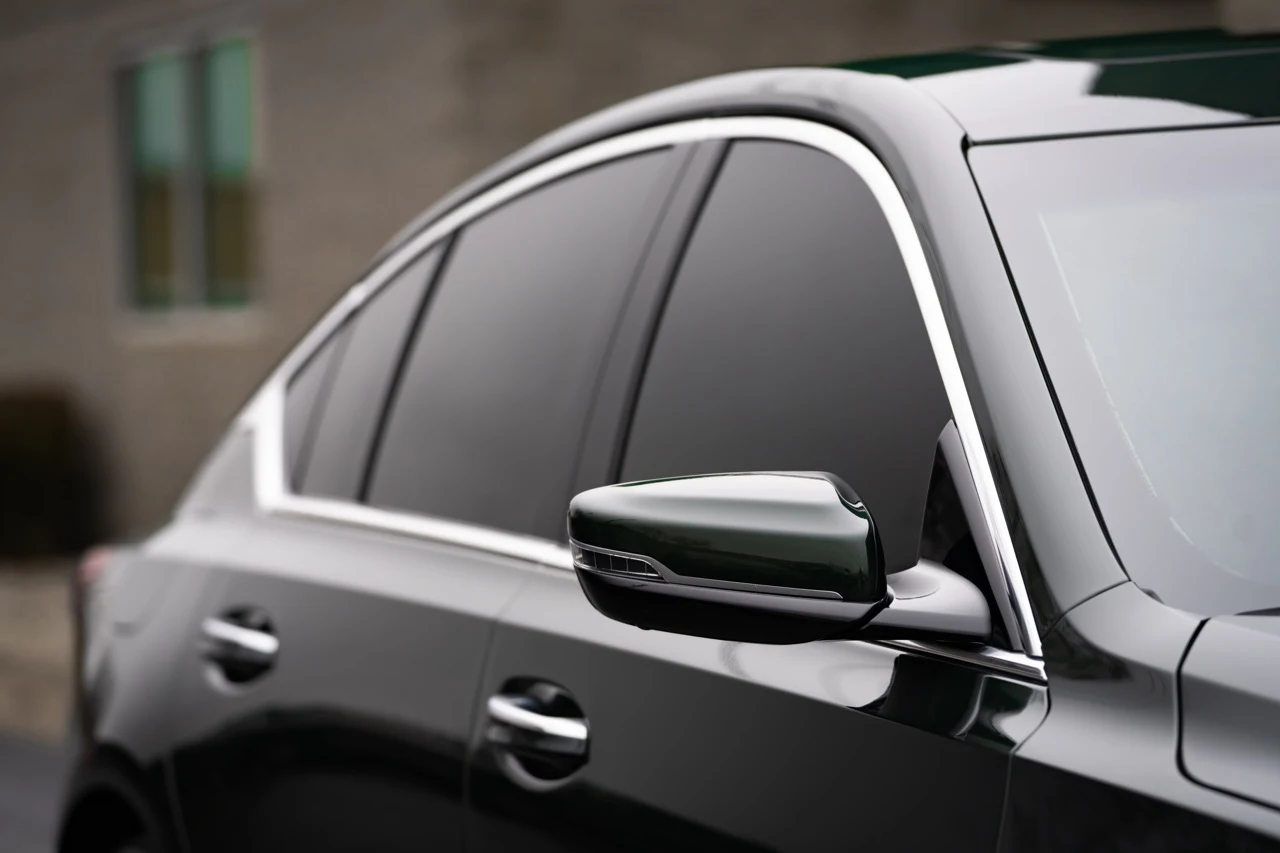 Window and trim detail on a dark sedan