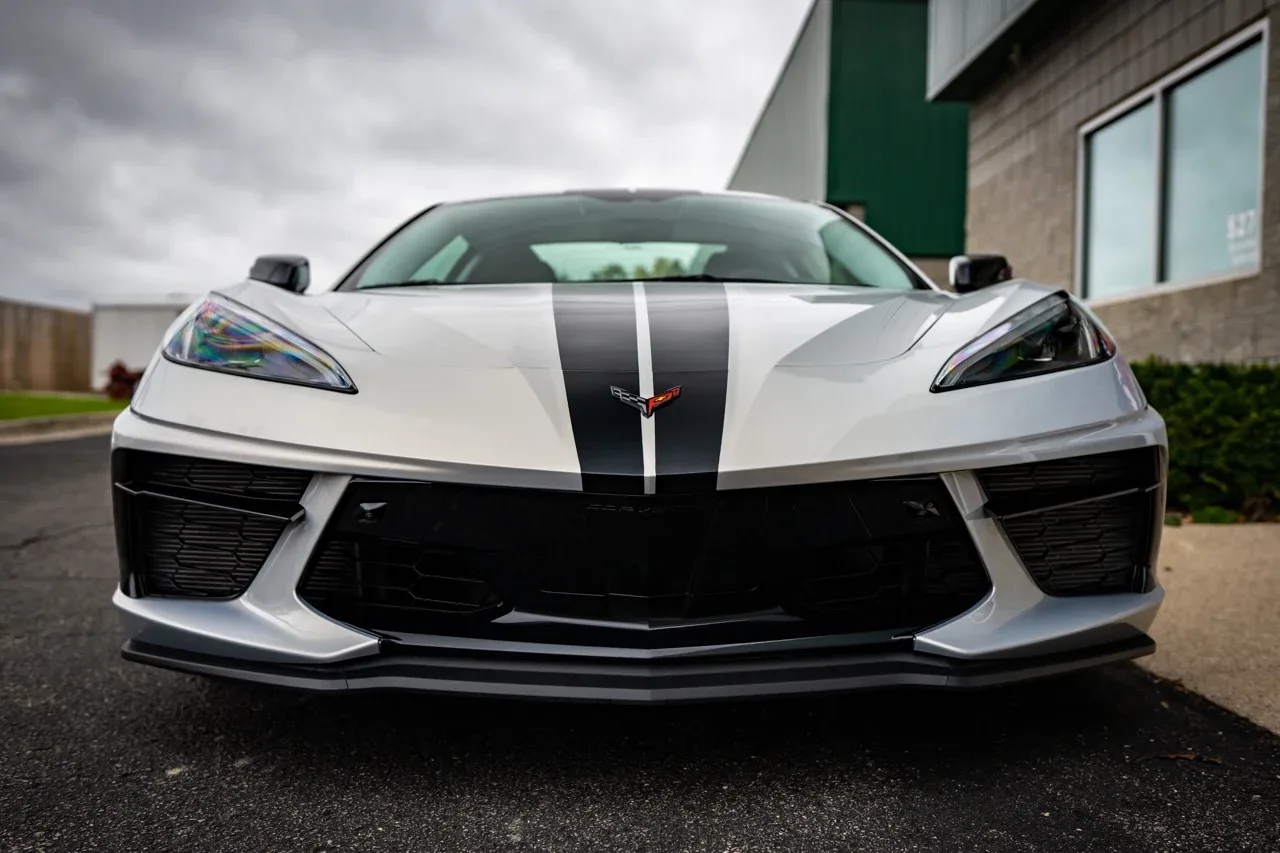 White Corvette C8 with black racing stripes