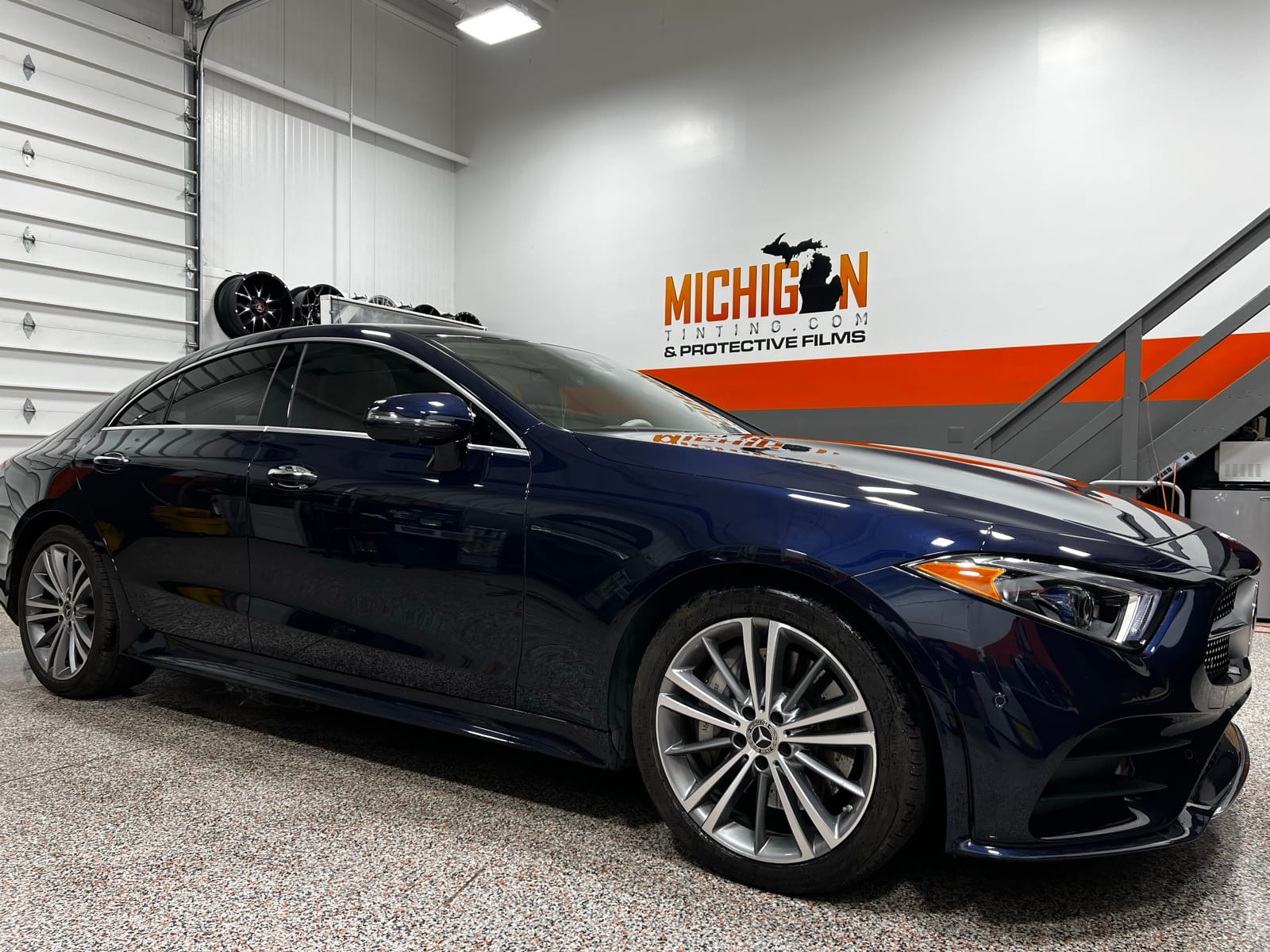 Blue BMW sedan tinted in the shop
