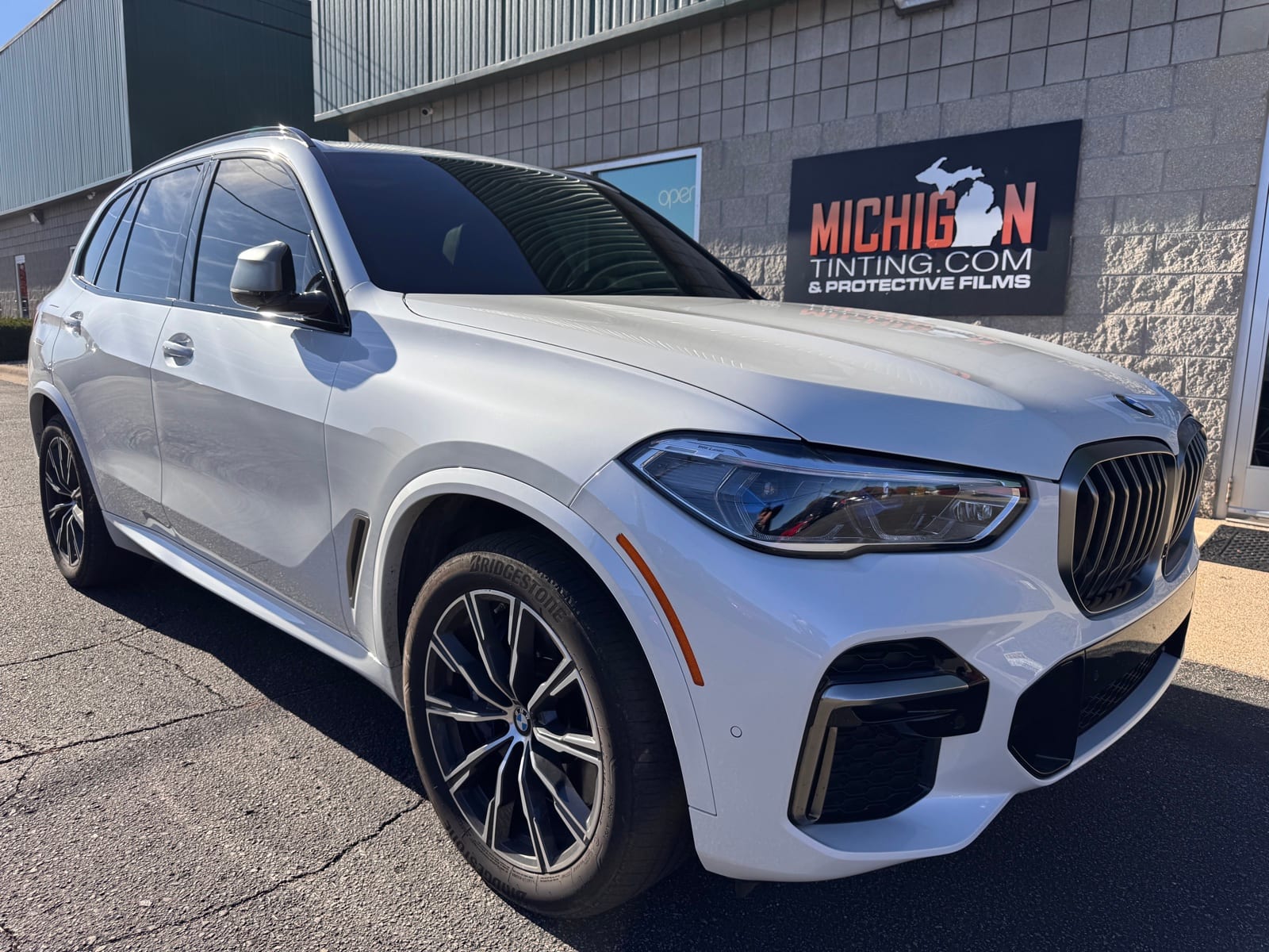 White BMW X5 tinted in the shop