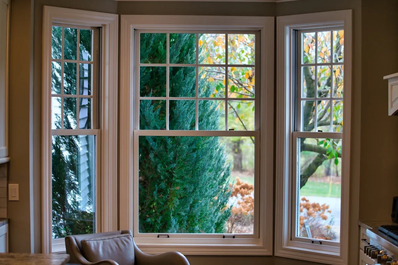 Bay window with tinted grid panes over a garden