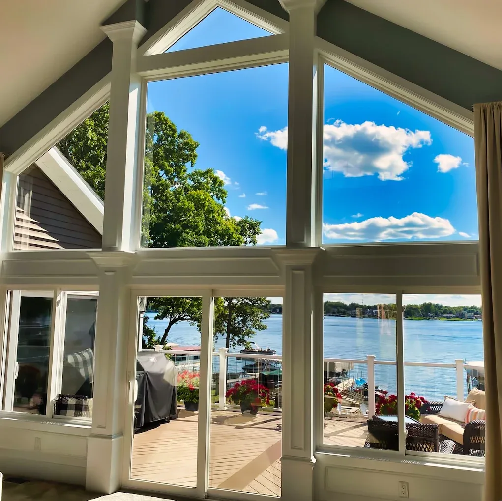 Sunroom windows framing a lake view