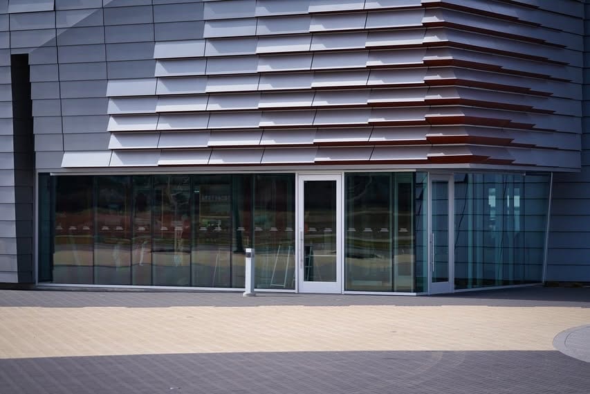 The glass frontage of a modern commercial building at street level