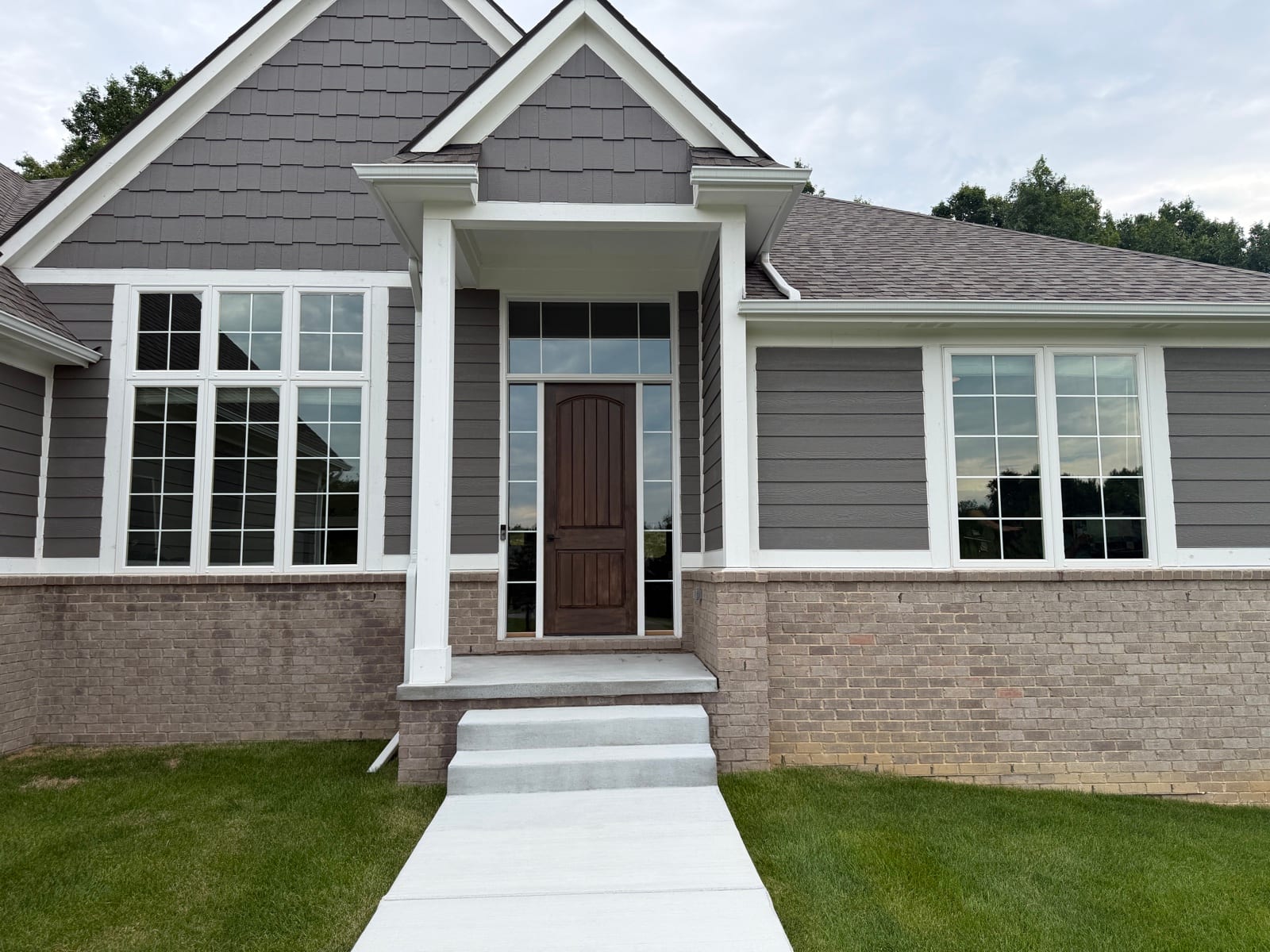 Home exterior with a tinted arched gable window