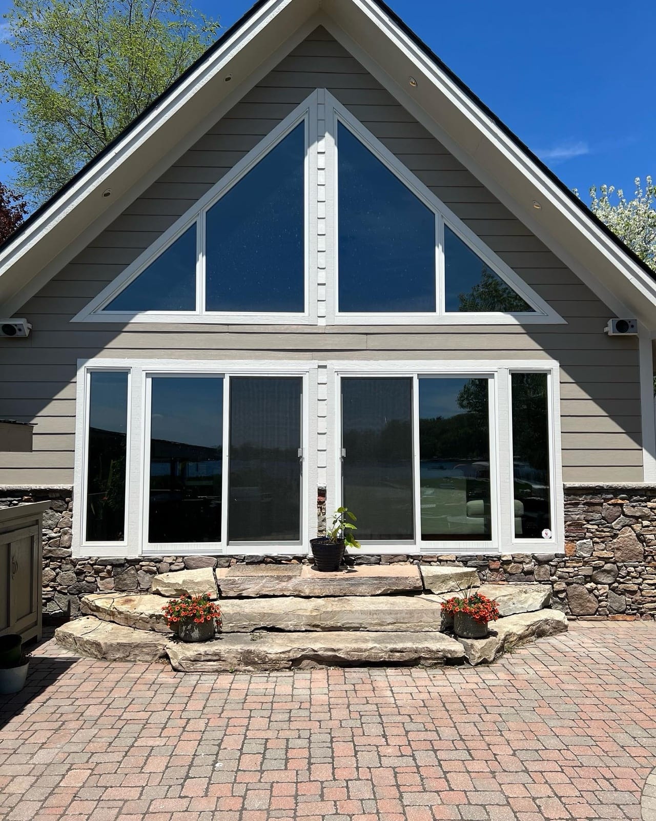 Home with a tinted floor-to-ceiling gable window