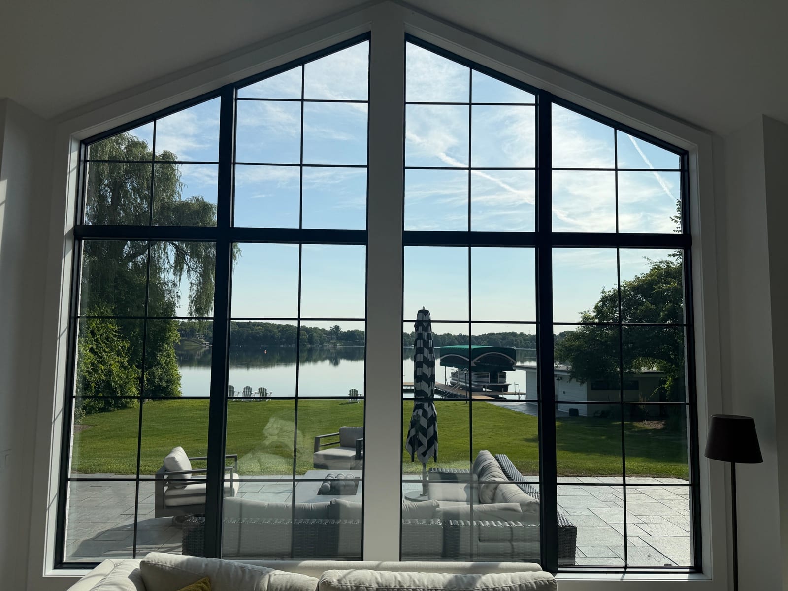 Black-frame lake windows with heat-control film from inside