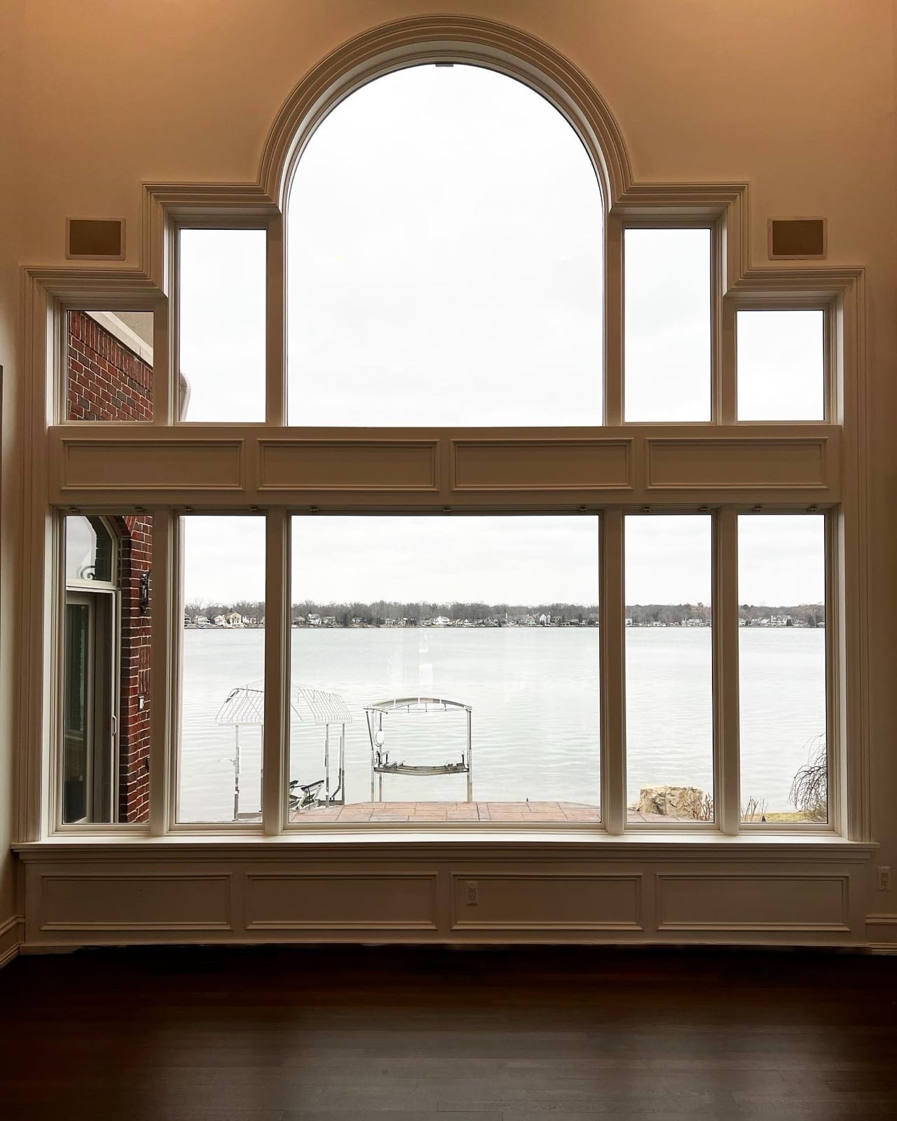 Tinted picture window framing a lake view
