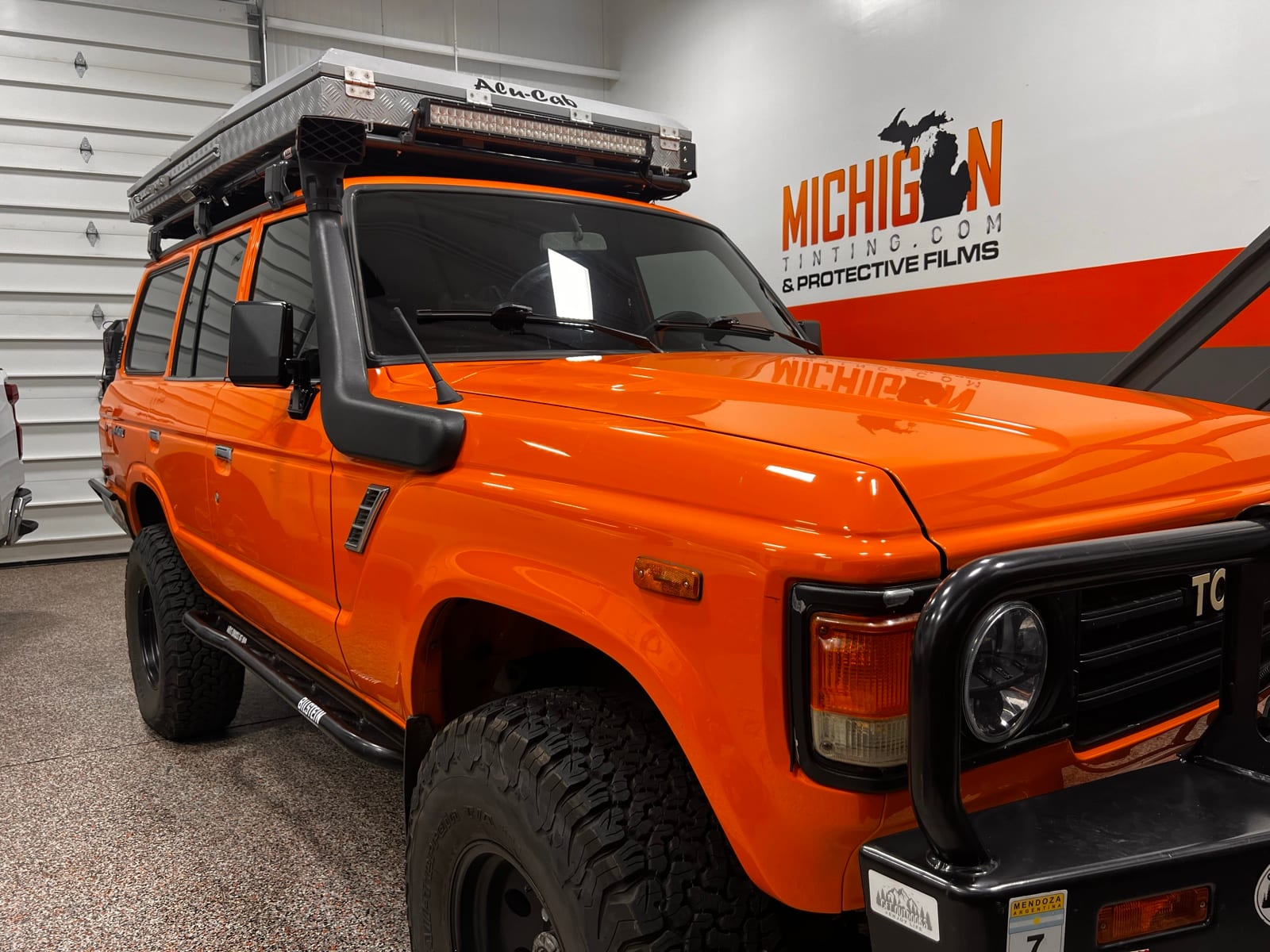 Orange Toyota Land Cruiser FJ60 overland build with protective film