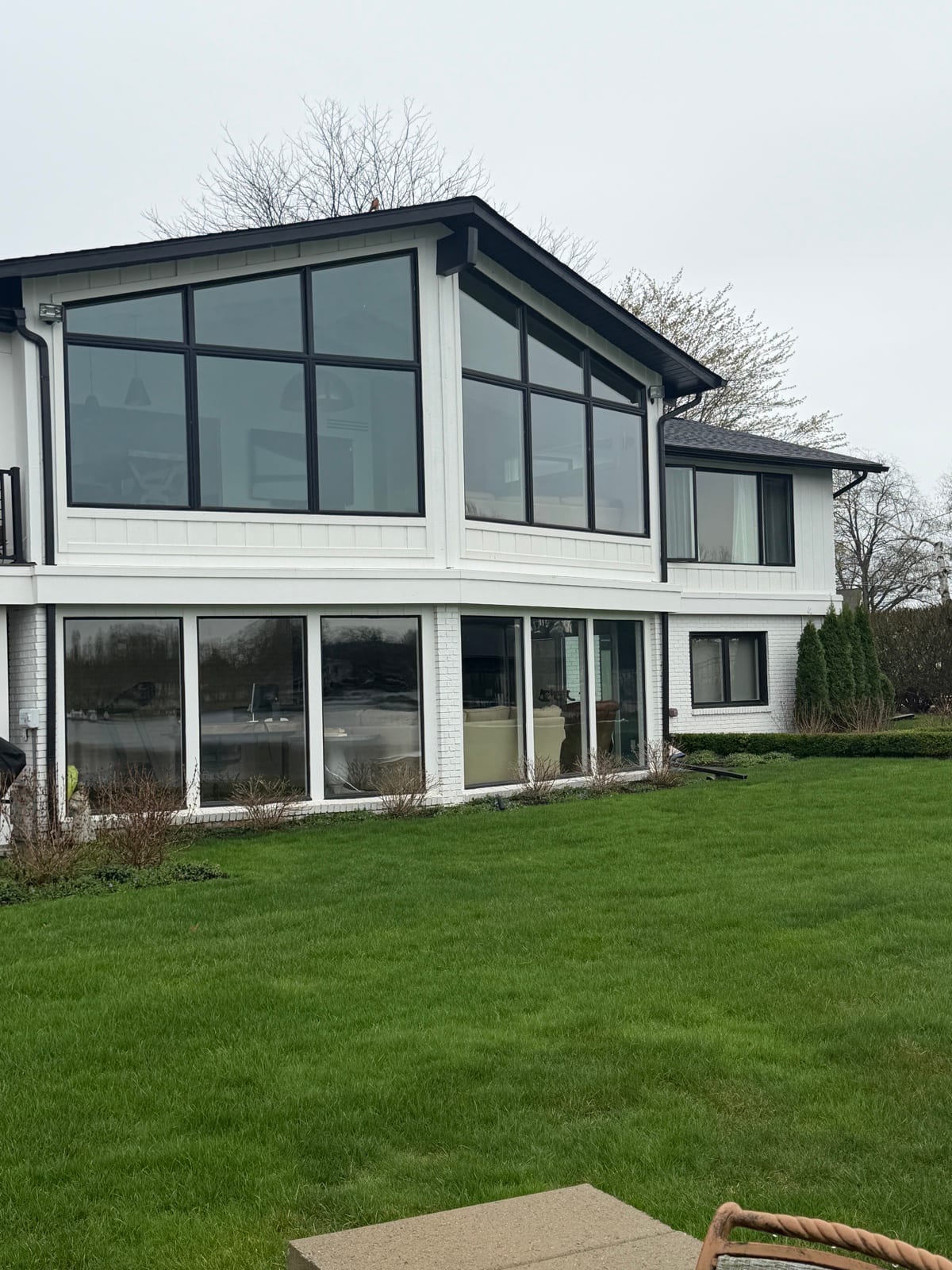 Modern white home with tinted black-frame windows