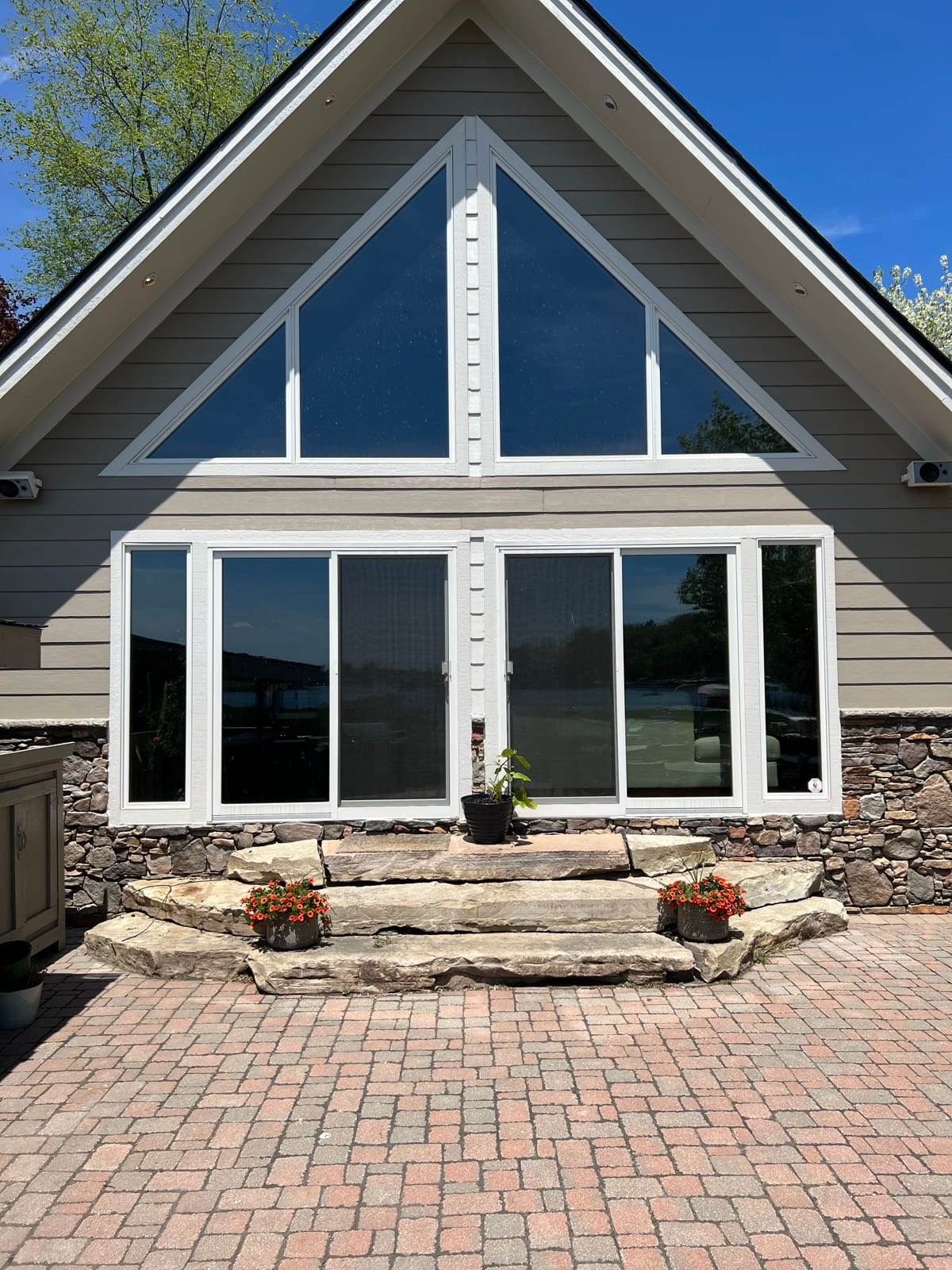 Stone-based home with a tinted gable window wall